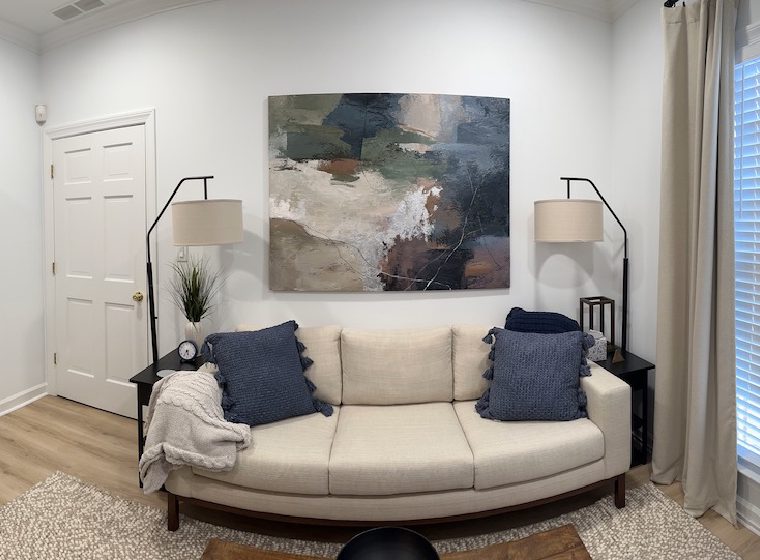 Calming therapy room with a sofa, soft lighting, and warm decor